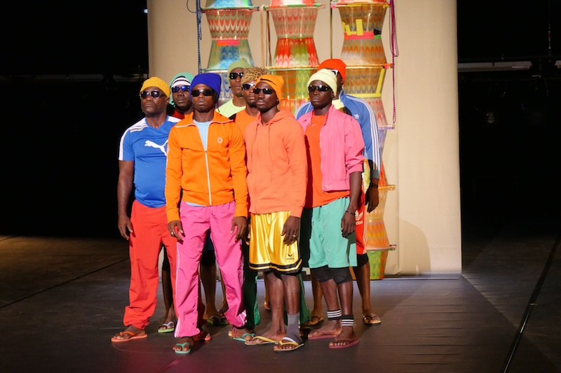 A group of black men looking out in sunglasses and bright colored athletic apparel